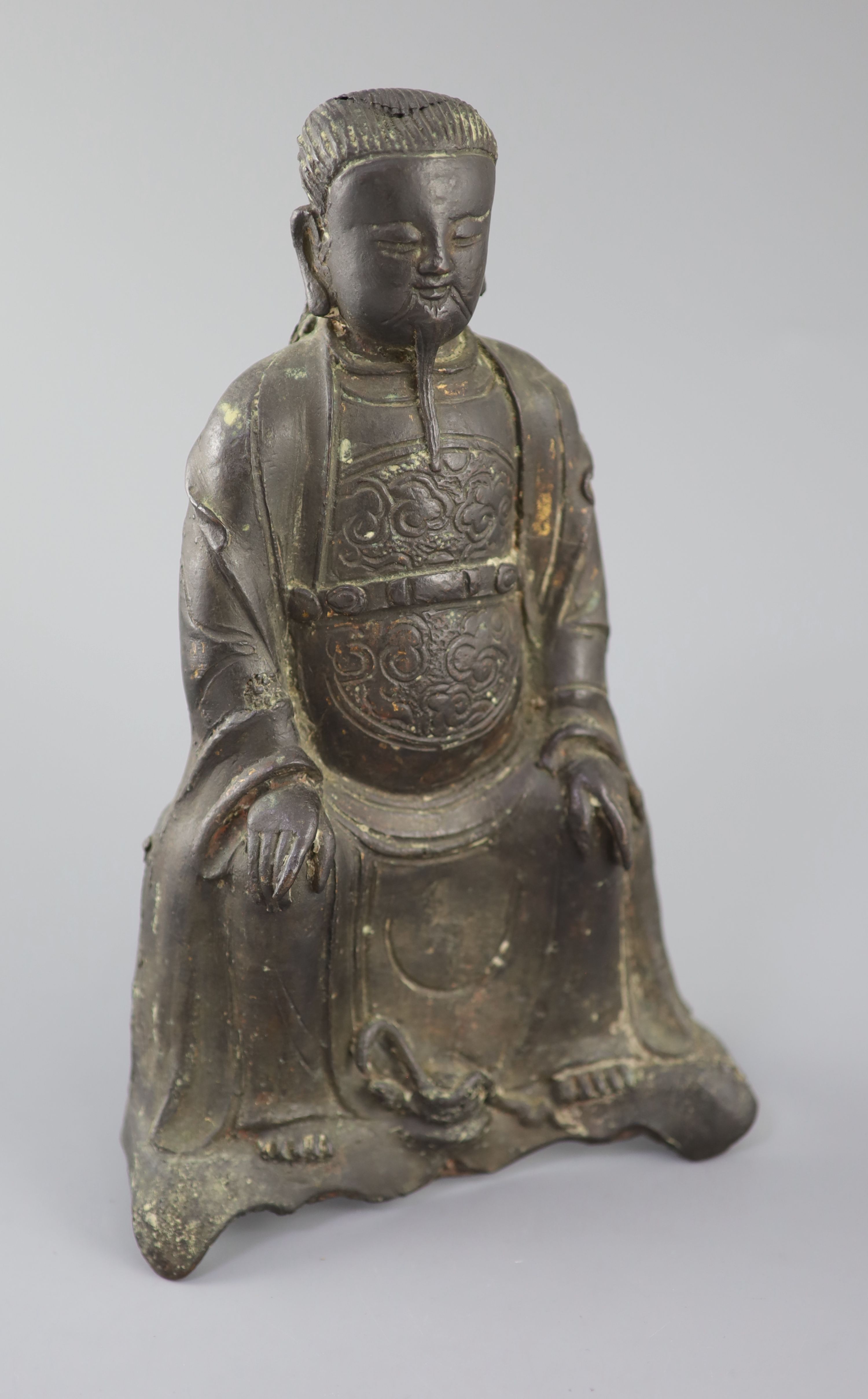 A Chinese bronze seated figure of Zhenwu, late Ming dynasty, 29cm high, casting faults, Provenance - A. T. Arber-Cooke